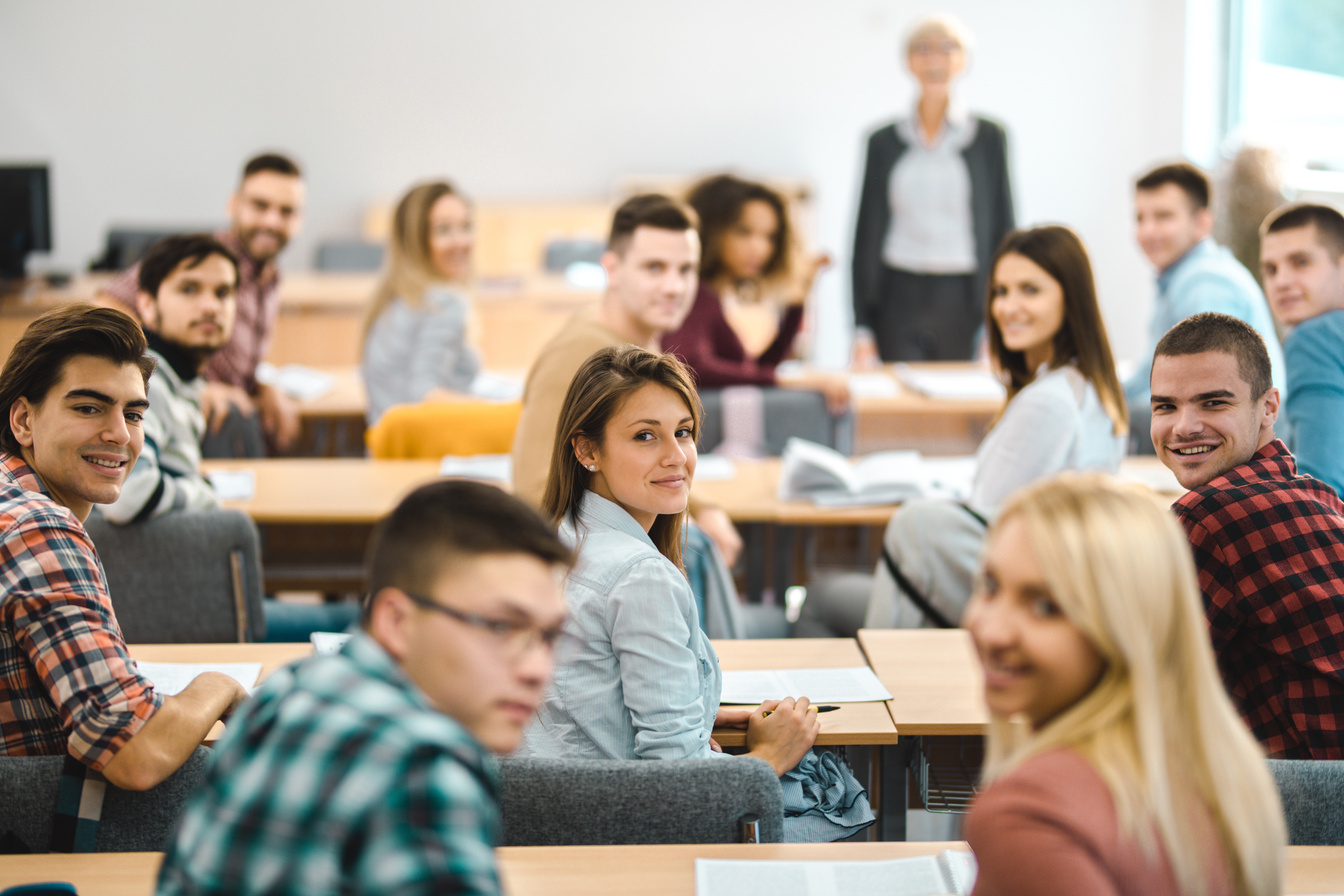 College students attending a class at lecture hall.